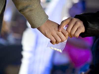 Hands exchanging pills